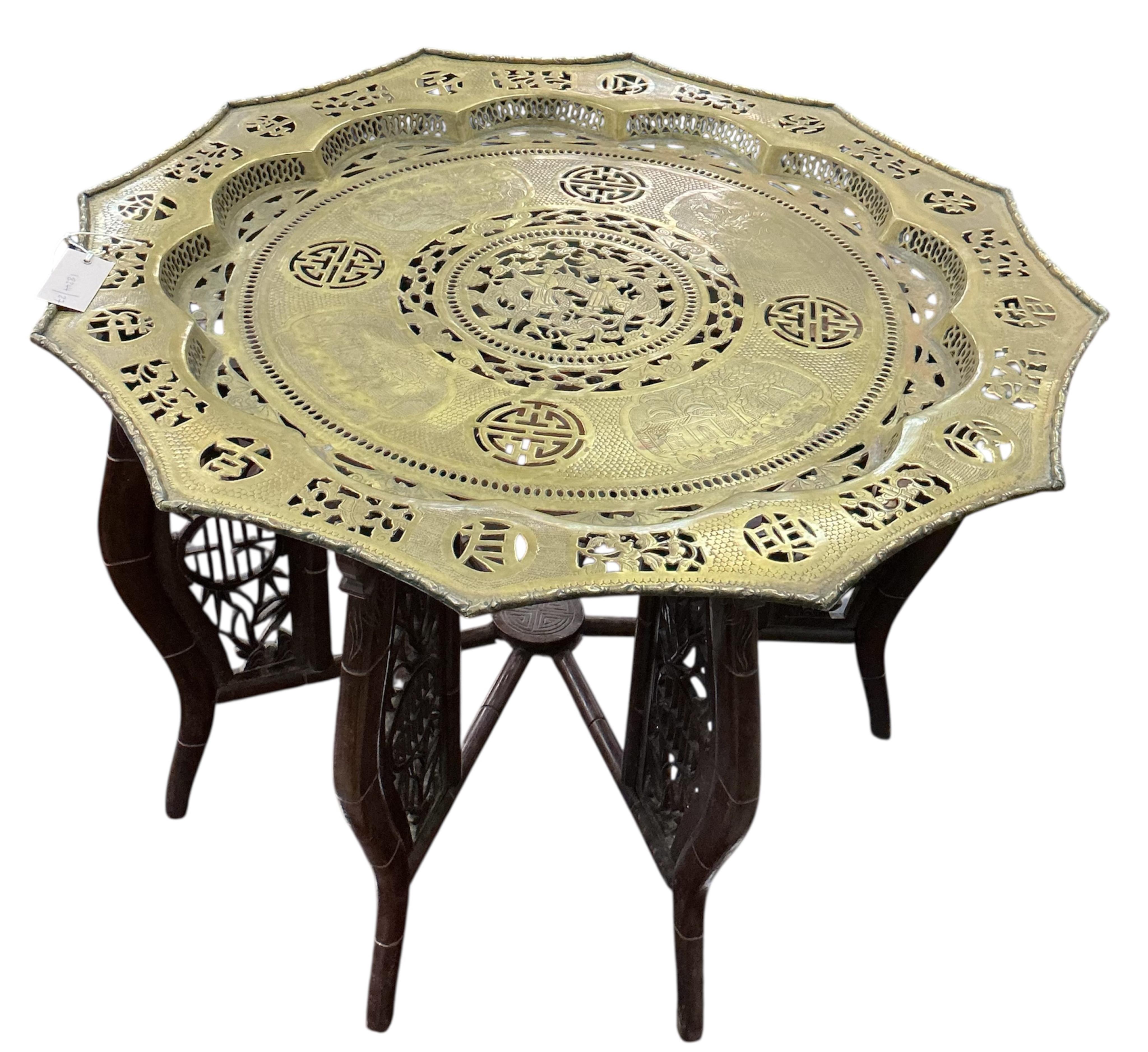 A Chinese pierced brass tray top table on hardwood folding stand, width 76cm, height 56cm